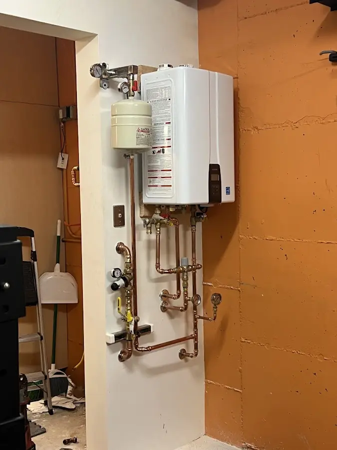 Plumbing technician inspecting water heater connections in Chattanooga Valley